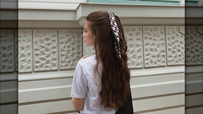 Brunette with half-up ponytail, scarf