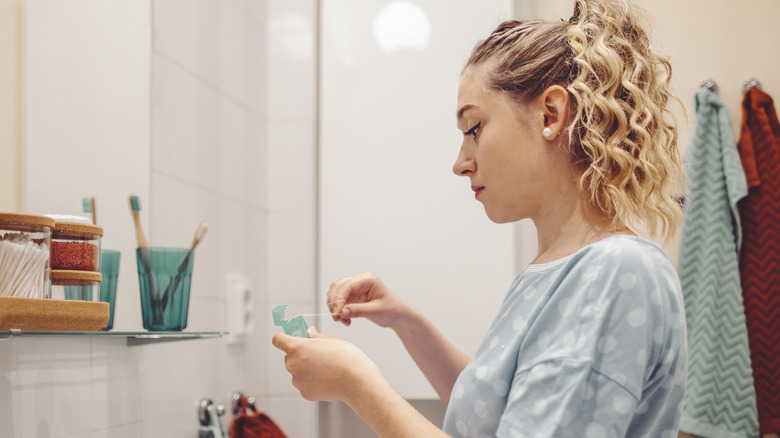 A woman using dental floss