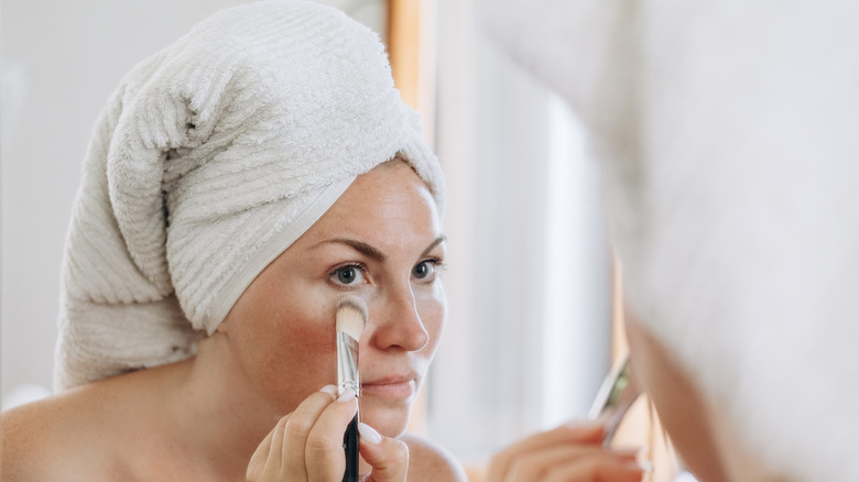 Woman using a flat makeup brush