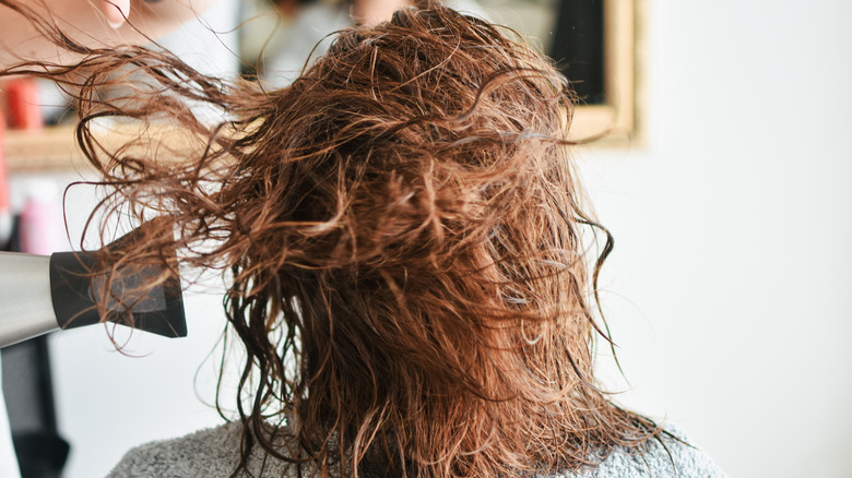 Brunette hair receiving treatment