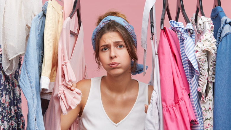 woman in clothing rack 