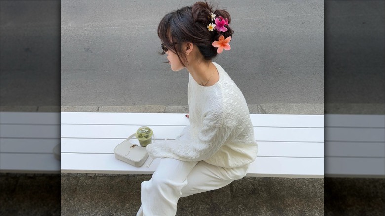 Updo with curtain bangs and flower details