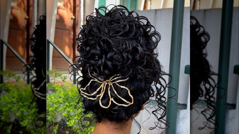 woman with high bun curly hair