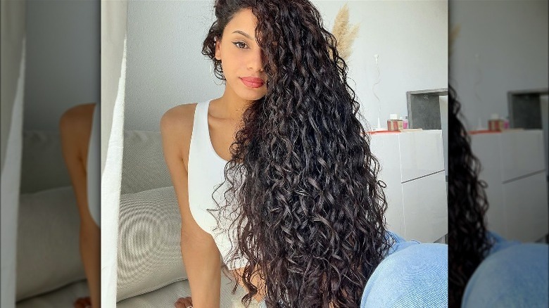 woman with hip-length curly hair