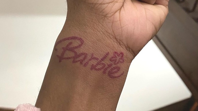 woman with barbie wrist tattoo