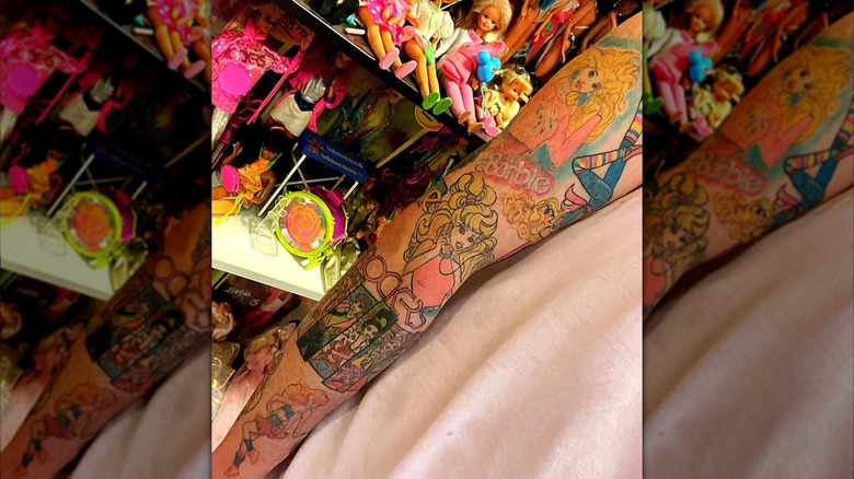 arm with barbie sleeve tattoos