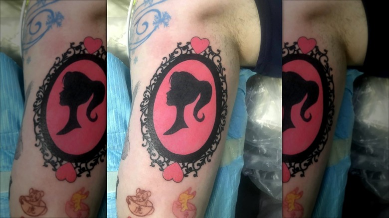 barbie silhouette in ornate frame tattoo