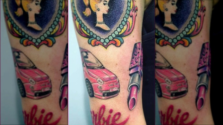 arm with barbie sticker sleeve tattoos