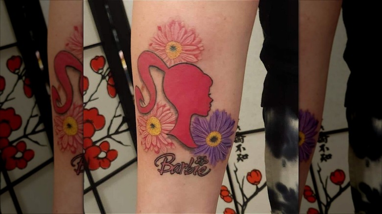 barbie silhouette tattoo with flowers