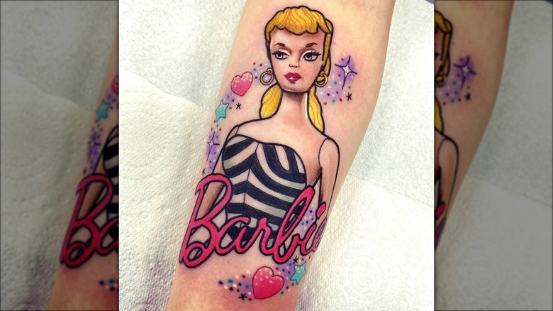 arm with vintage barbie tattoo