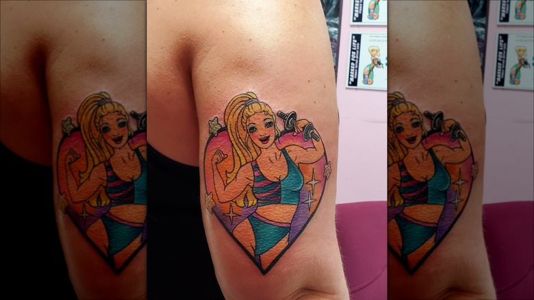 arm with workout barbie tattoo