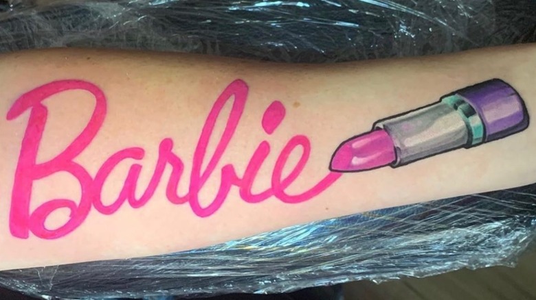 arm with barbie name tattoo