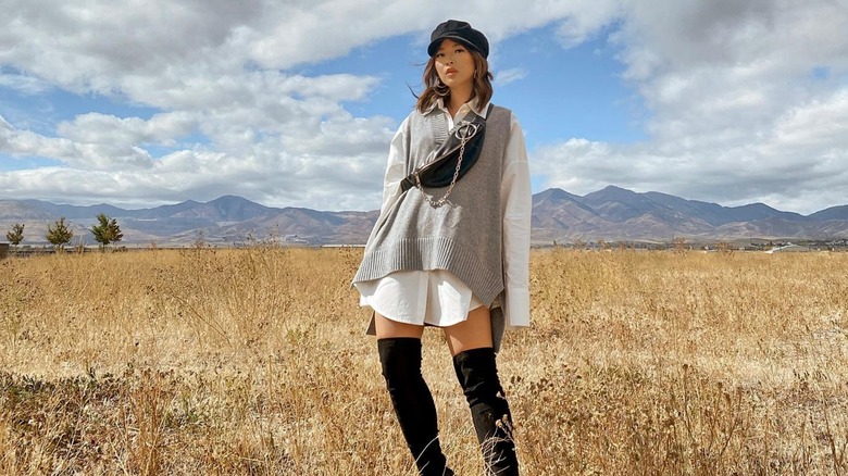 woman wearing sweater vest over dress