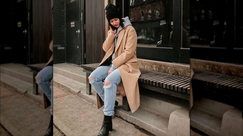 woman wearing beige coat and gray hoodie