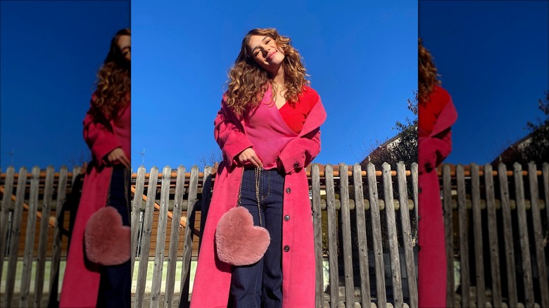 woman wearing pink trenchcoat and sweater