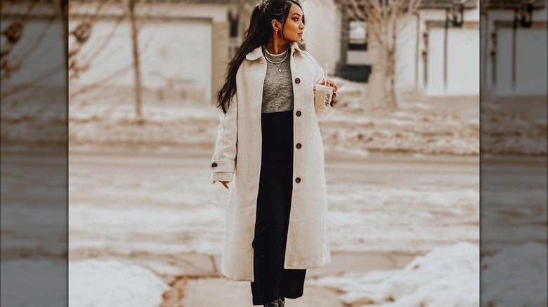 woman wearing trenchcoat and maxi skirt