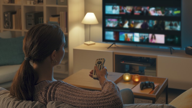 woman sitting on couch watching tv