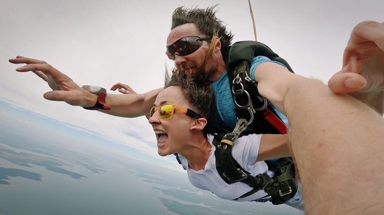 woman and man tandem skydiving