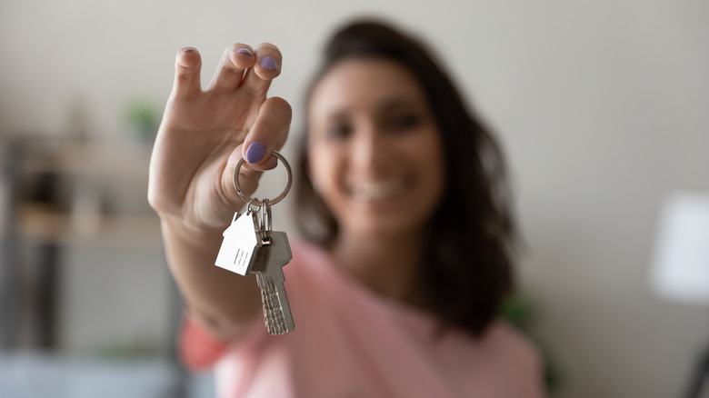 woman smiling holding new house keys
