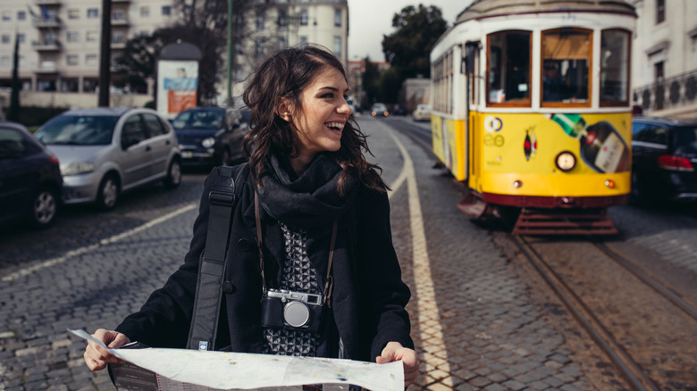 woman holding map in new city