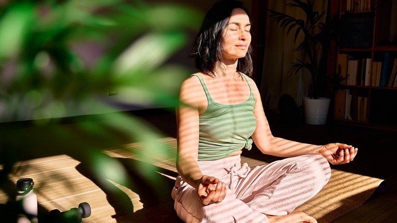 woman sitting cross legged meditating