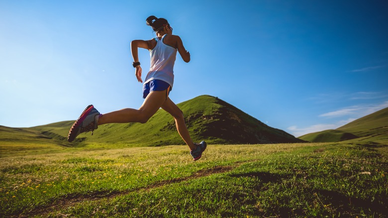 woman running on grass trail