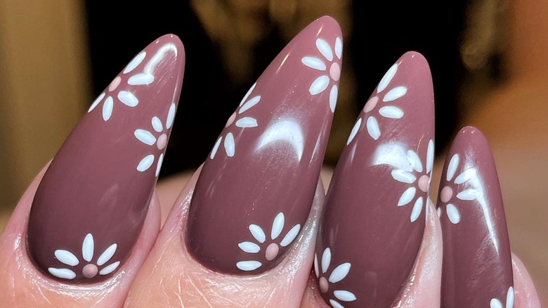 Plum-colored daisy nails