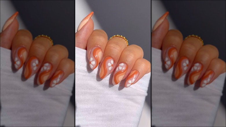 Clear nails with orange swirl design