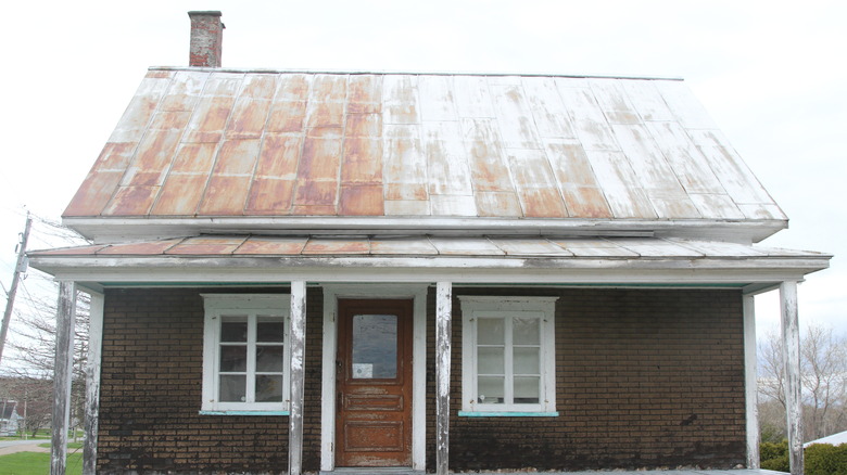 House with rusted tin roof