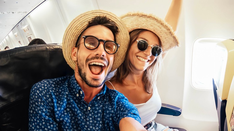 a happy couple on a plane