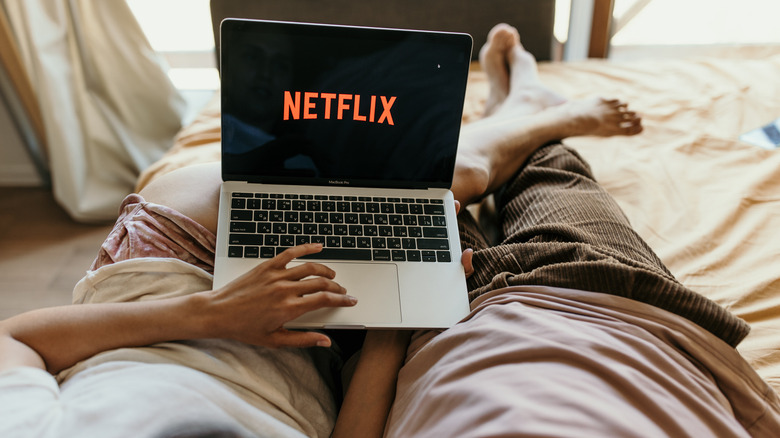 couple watching netflix in bed