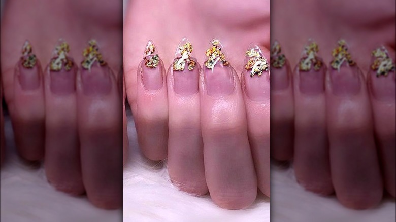 Gold on a clear embellished manicure
