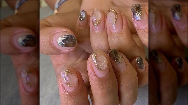 Gold embellished nude manicure