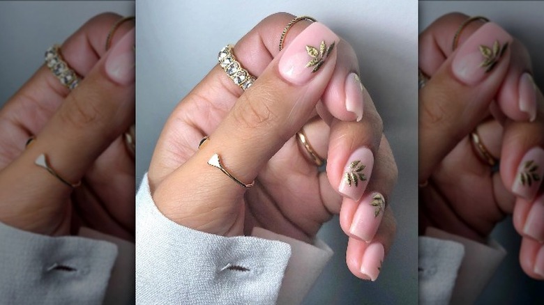 Nude nails with a golden leaf design