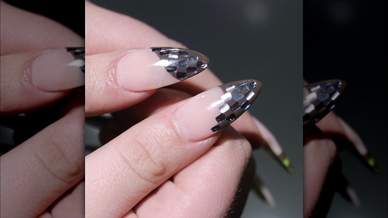 woman with chrome checkered nails