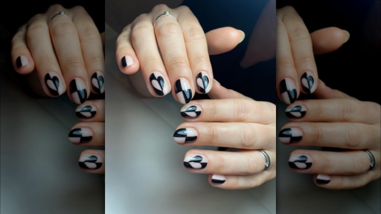 woman with checkered heart nails