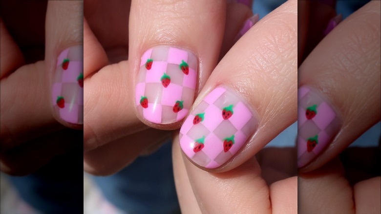 woman with pink checkered strawberry nails
