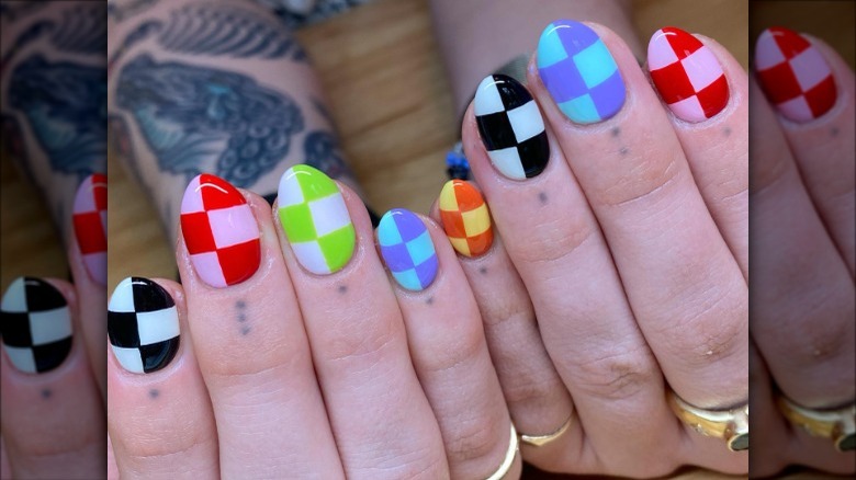 woman with colorful checkered nails