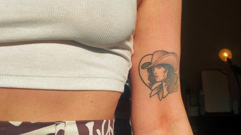 Cowgirl tattoo on arm