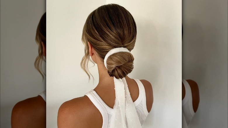 Chignon hairstyle with white chiffon ribbon 