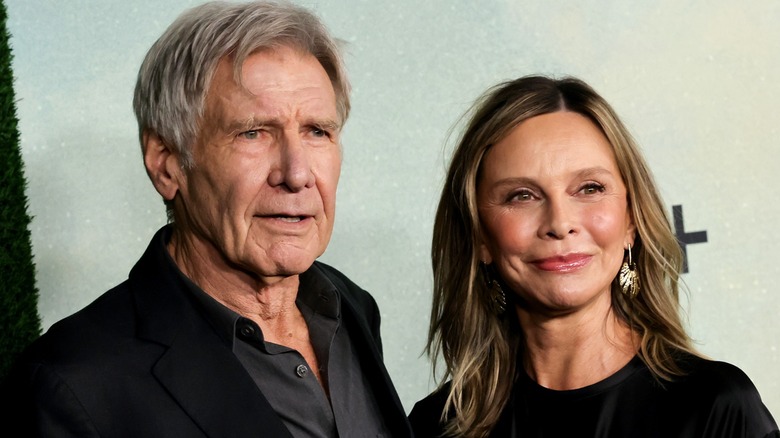 Harrison Ford and Calista Flockhart posing on the red carpet.