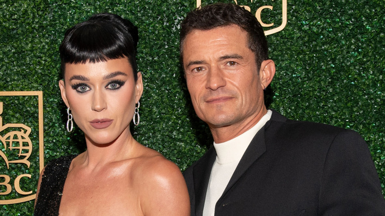 Katy Perry and Orlando Bloom posing on the red carpet.