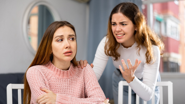 woman annoying another woman