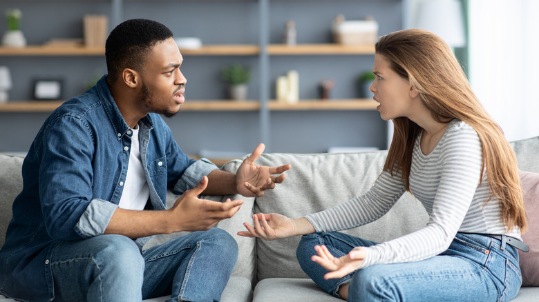 Couple arguing on couch