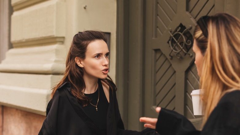 two women arguing outside