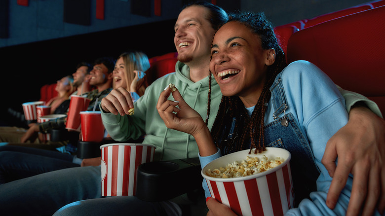 Family watches movie in theater