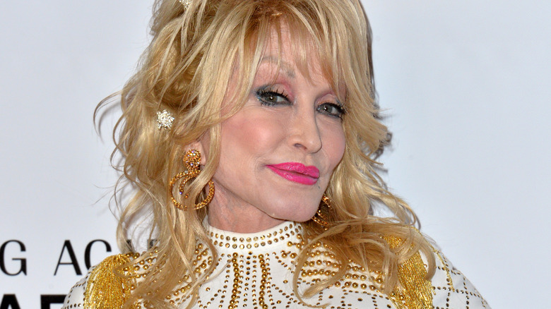 Dolly Parton smiling on red carpet