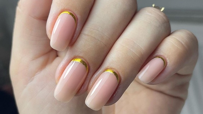 nude nail polish with gold cuffs