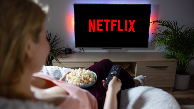 Woman with popcorn watching Netflix