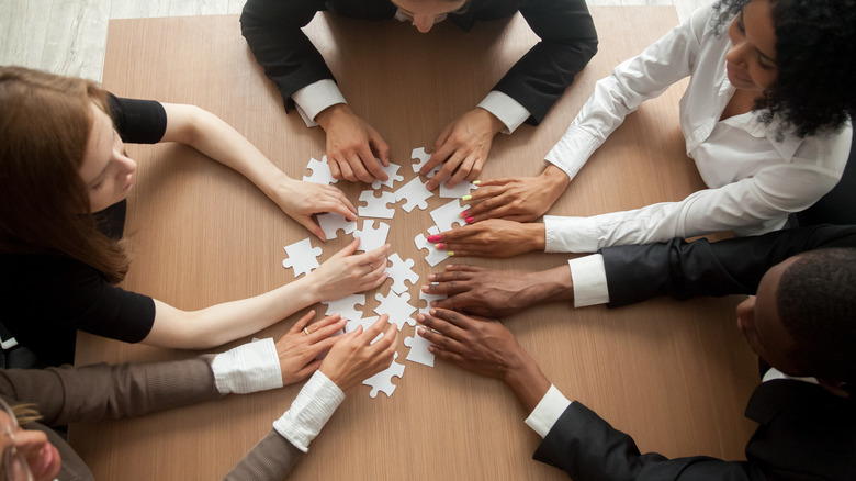 People building a puzzle together